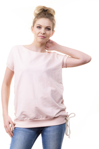 Adult woman presenting her casual beautiful outfit, short sleeved pink top and jeans. - Photo, Image