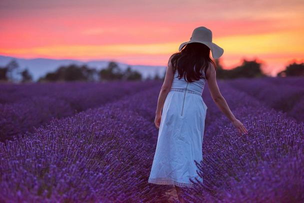 woman portrait in lavender flower fiel in sunset and night time - Фото, зображення