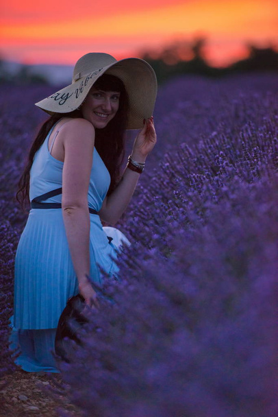 woman portrait in lavender flower fiel in sunset and night time - Foto, Bild