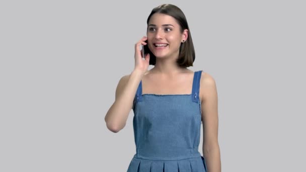 Young emotional woman talking on telephone. - Felvétel, videó