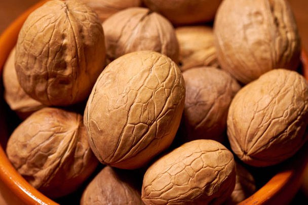 Walnut on brown wooden background. Selective focus - Photo, image