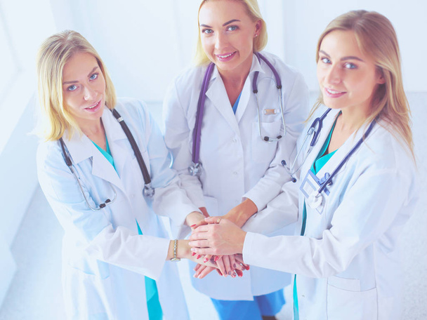Doctors and nurses in a medical team stacking hands. - Фото, зображення