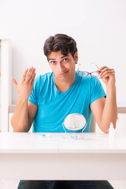 Man trying contact lenses at home - Photo, image