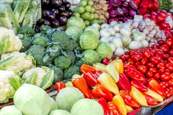 Vegetable farmer market counter. Colorful heap of various fresh organic healthy vegetables at grocery store. Healthy natural food background - Photo, image