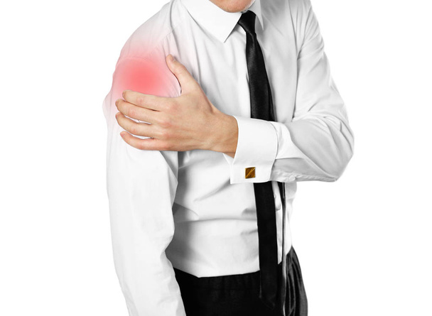Businessman in a white shirt and tie holding hand. Shoulder pain. Isolated on white background. - Zdjęcie, obraz