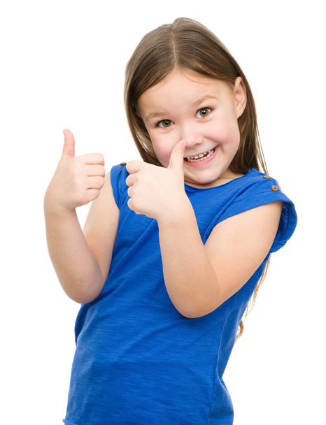 Little girl is showing thumb up gesture - Zdjęcie, obraz