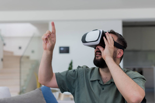 handsome hipster man with beard trying vr glasses at modern home - Photo, Image