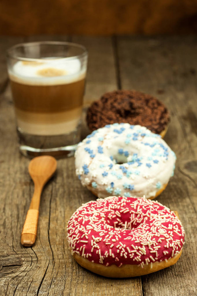 Unhealthy food. Donuts on a wooden table. Coffee to dessert. Dangers of obesity and diabetes. Sales of sweets. Donuts for breakfast. - Фото, зображення