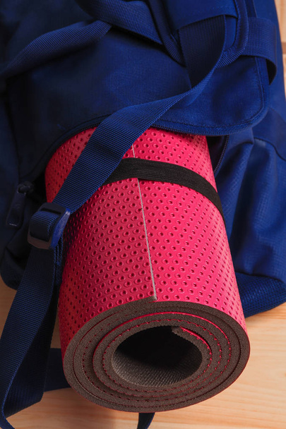 Pink yoga mat in a blue gym bag. Set for fitness, yoga and massage. - Photo, Image