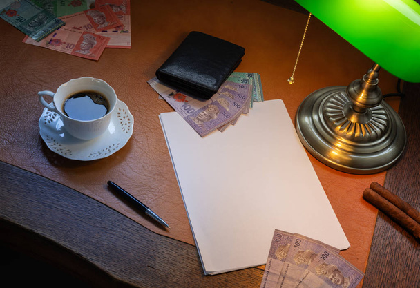 Malaysian money, Ringgit, on a stylish desk lit with a banking lamp - Fotoğraf, Görsel