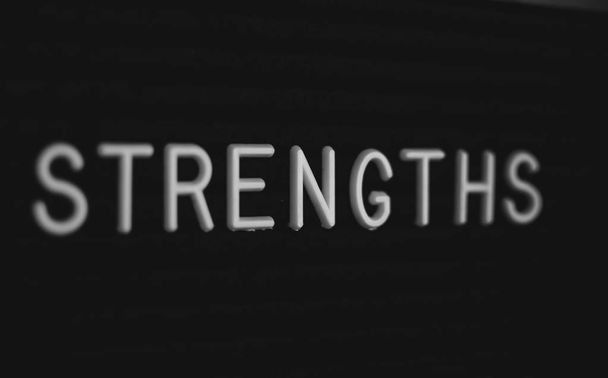 Word strengths written on the letter board. White letters on the black background - Photo, Image