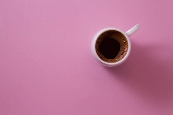 Cup of coffee on a bright background color light violet photo from above. - Foto, Imagem