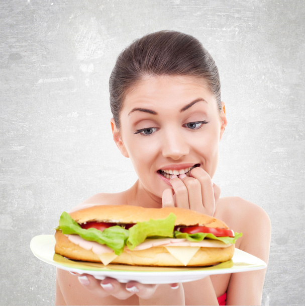 om te eten of niet te eten een grote sandwitch - Foto, afbeelding
