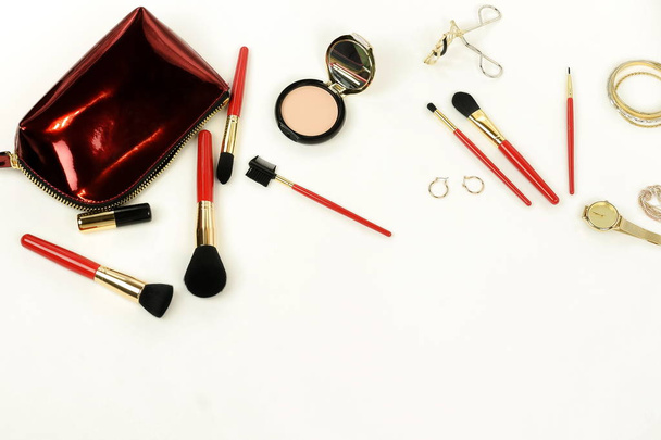 Makeup cosmetic products ,brushes set and cosmetic bag top view on white background. Professional makeup tools . Women accessories. Flat lay. Copy space - Photo, Image