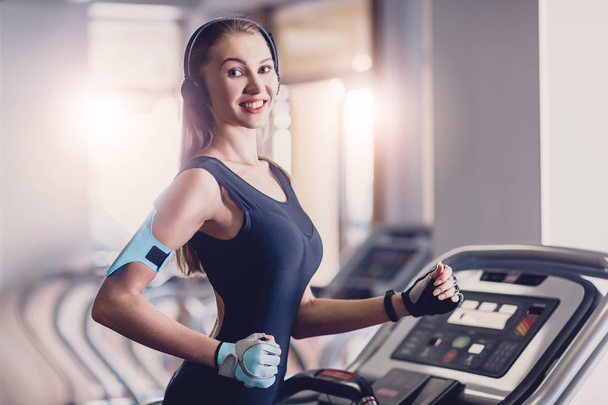 Happy women jogging on a treadmill for health. - Φωτογραφία, εικόνα