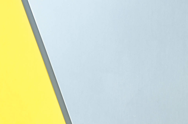 Metal splitted by a line gray yellow color background of modern siding house wall. - Foto, afbeelding