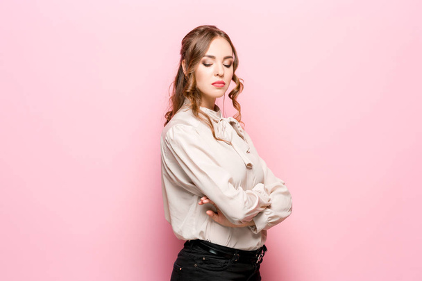 The serious frustrated young beautiful business woman on pink background - Photo, image