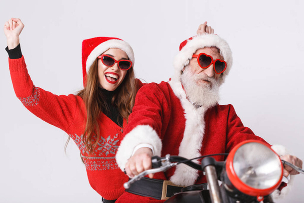 Santa Claus And Young Mrs. Claus Riding A The Motorcycle - Fotó, kép