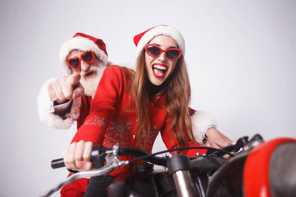 Santa Claus And Young Mrs. Claus Riding A The Motorcycle - Foto, afbeelding