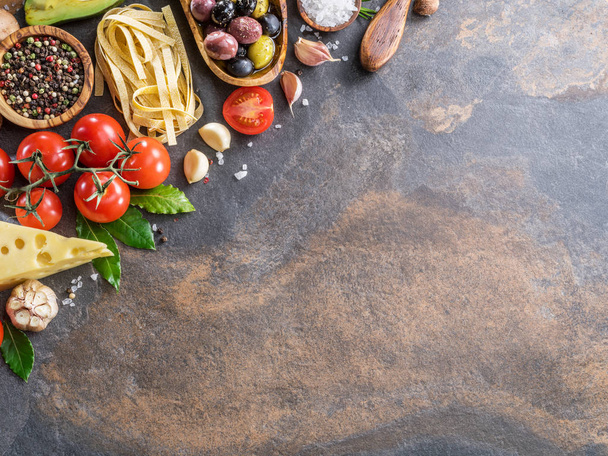Pasta, spices and vegetables. Popular mediterranean or italian food ingredients. Top view. - Foto, Imagen