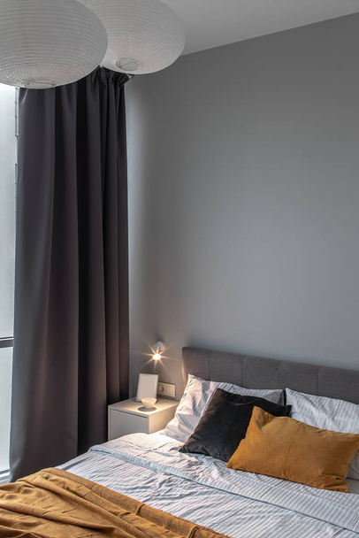 Great bedroom in modern style with gray wall and luminous lamp - Valokuva, kuva