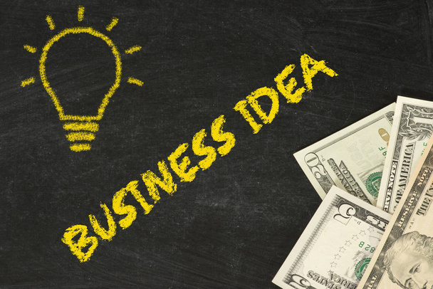 A chalk board, dollar bills and a business idea - Foto, Bild