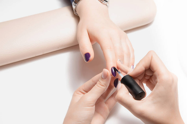 Accurate work of master on manicure in womans salon. Coating clear nail Polish. - Valokuva, kuva