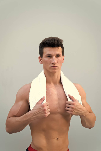 Sportsman with towel on neck on grey background - Photo, Image