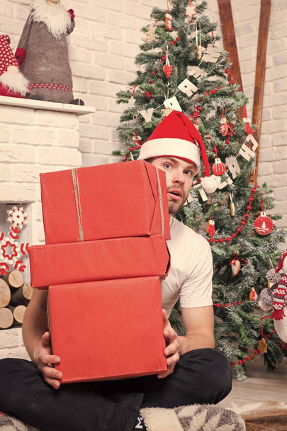 Man santa with boxes at christmas tree - Фото, зображення