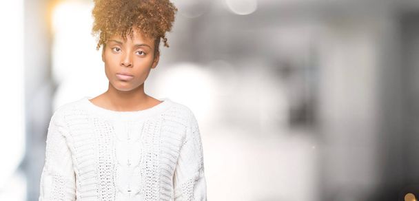 Beautiful young african american woman wearing winter sweater over isolated background Relaxed with serious expression on face. Simple and natural looking at the camera. - Φωτογραφία, εικόνα