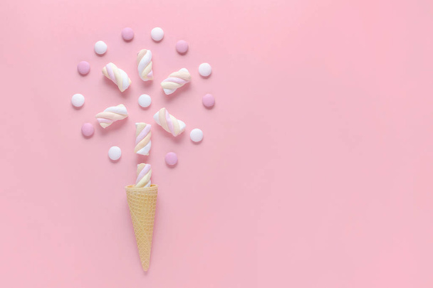 candy, marshmallow and ice cream waffle cone on pink background, concept image - Photo, Image