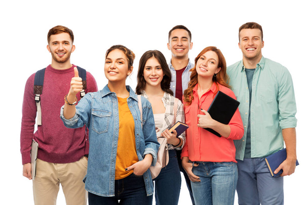 education, high school and people concept - group of smiling students with books showing thumbs up over white background - Φωτογραφία, εικόνα