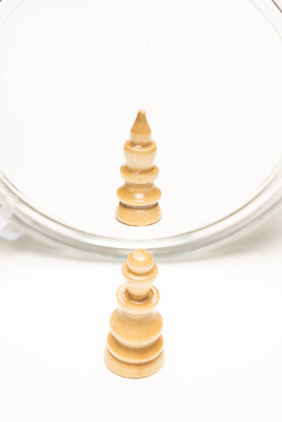Chess pieces facing a mirror. Business and motivational concepts. High-resolution image. - Zdjęcie, obraz