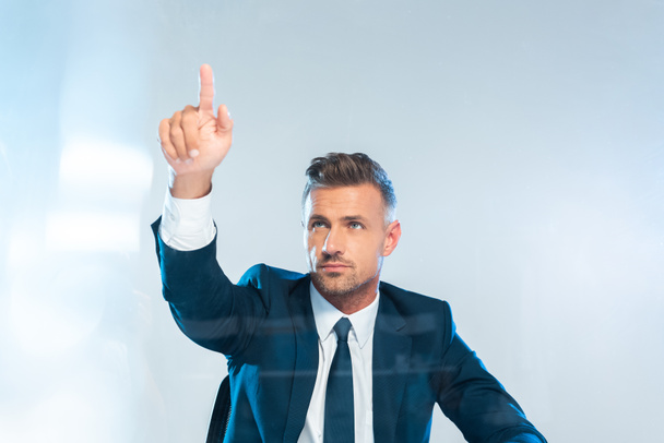handsome businessman pointing on something isolated on white, artificial intelligence concept - Photo, Image