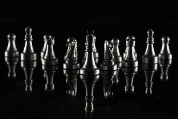 Chess pieces on black reflective background. High resolution image for sport and finance industry. - 写真・画像