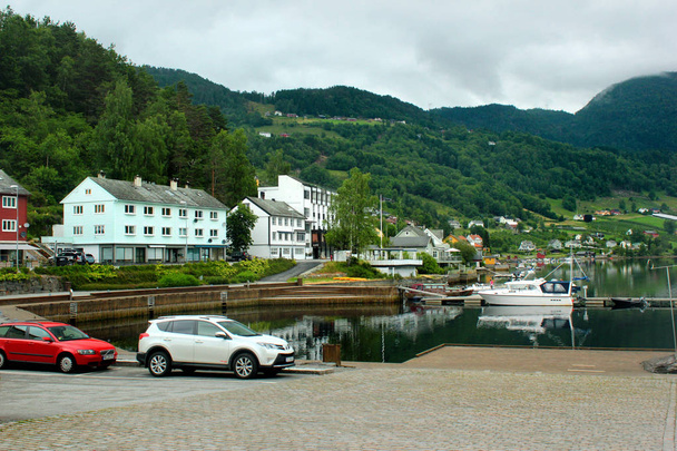 Ulvik, Norway - June 24, 2018: View of Ulvik village in Hordaland county, the popular resort at the end of Ulvikafjord, with coastal promenades and beautiful rural landscapes. - Fotografie, Obrázek