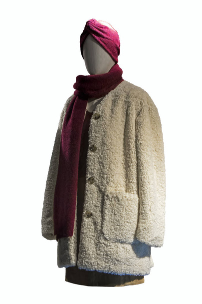 Stylish female burgundy scarf and ivory coat on mannequin. Female mannequin with muffler, skirt and overcoat. Female autumn outfit - Photo, Image