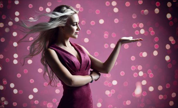 Blonde woman beautician cosmetologist pointing hand with text space on purple pink with christmas celebration lights   - Fotoğraf, Görsel