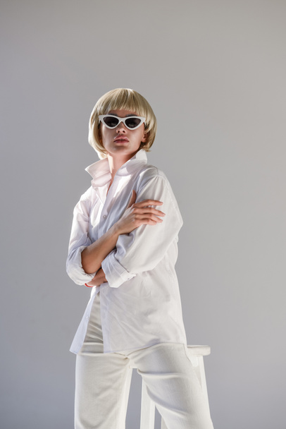 attractive blonde woman in sunglasses and fashionable white outfit isolated on white - Photo, Image