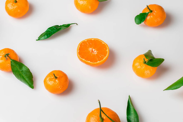 Background of fresh citrus with leaves on white. Flat lay. Top view - Фото, зображення
