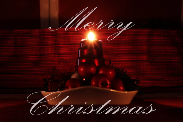 Merry Christmas greeting card with homemade christmas candlestick. One of four candles burning and showing beautiful rays. Wishing to you all the best. - Photo, Image