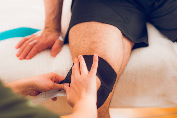 Knee treatment with kinesio tape - Photo, Image