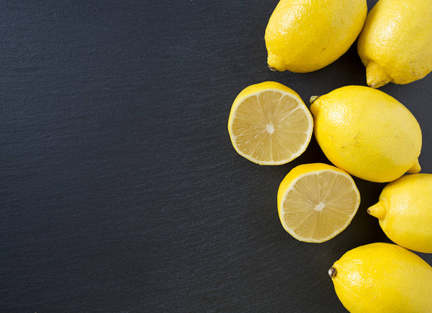 Fresh ripe lemons on chalkboard - Fotografie, Obrázek
