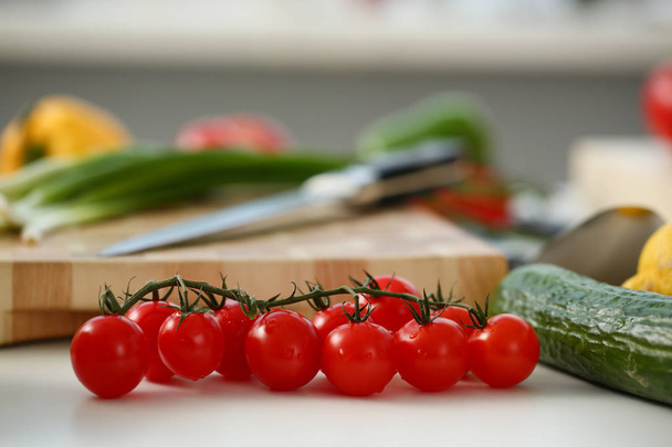 Cherry tomatoes lie on a cutting board - 写真・画像