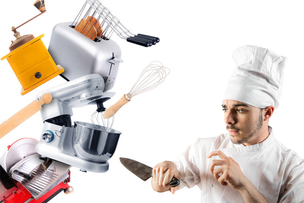 ένας σεφ με μαχαίρι που υπερασπίζεται τον εαυτό του από σκεύη κουζίνας - Φωτογραφία, εικόνα