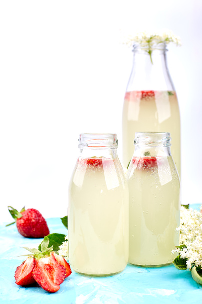 Kombucha tea with elderflower and strawberry on blue background. . Homemade fermented infused drink. Summer Healthy natural probiotic flavored drink. Copy spac - Photo, Image
