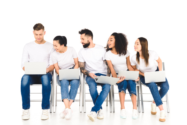 multicultural curious group of young people looking at laptop isolated on white - Fotografie, Obrázek