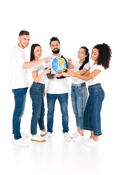 multicultural group of young people pointing with fingers at globe isolated on white - Valokuva, kuva