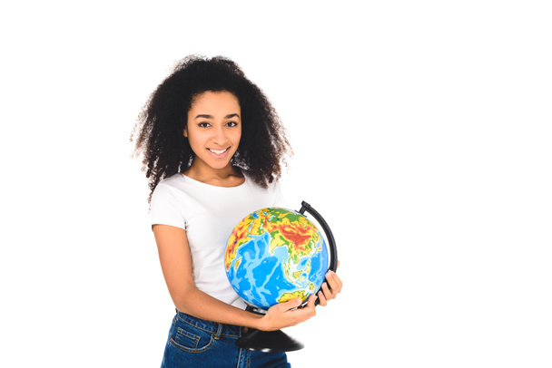 cheerful curly african american girl holding globe isolated on white - Fotó, kép