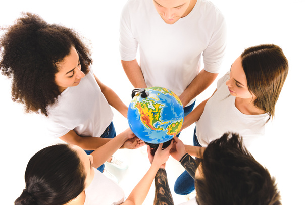 overhead view of multicultural group holding globe and standing in circle isolated on white   - Фото, зображення
